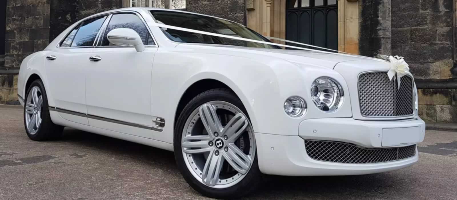 White Bentley Mulsanne wedding car with ribbons