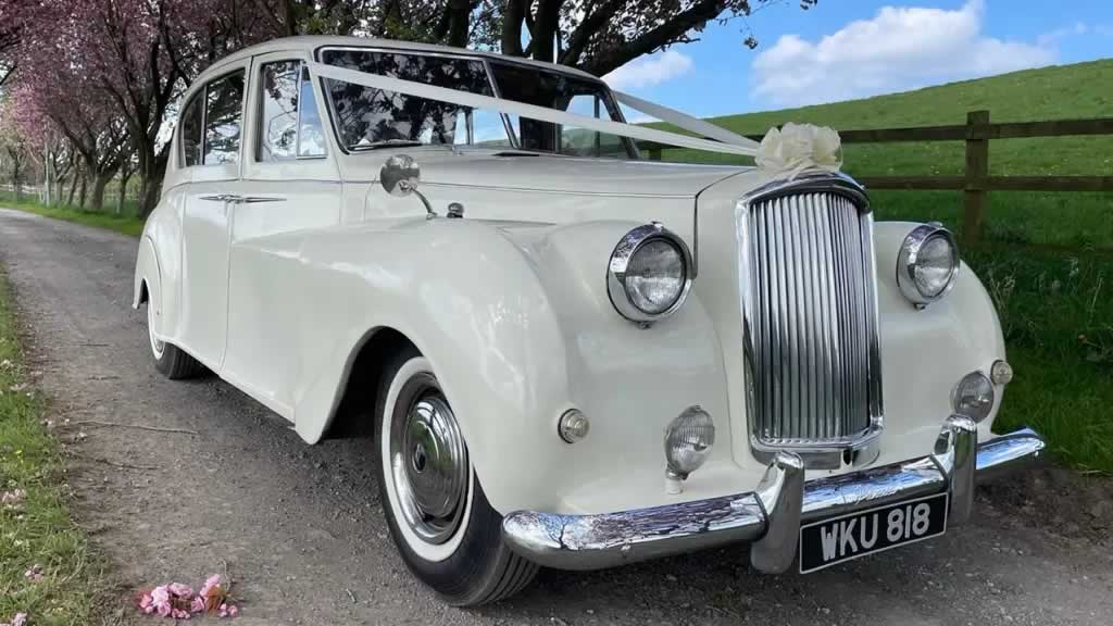 Whiate Austin Princess weddign car with ribbons on the bonnet