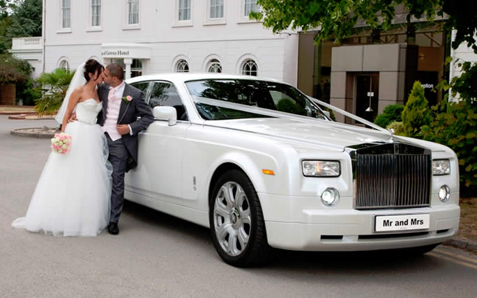 White Rolls-Royce Phantom I wedding car with bride and goom
