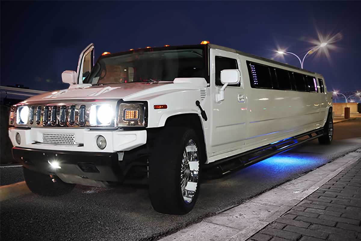 White Hummer H2 stretch limo on hire at night