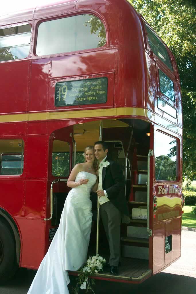 Bride and Groom on rear pltform of a London wedding bus